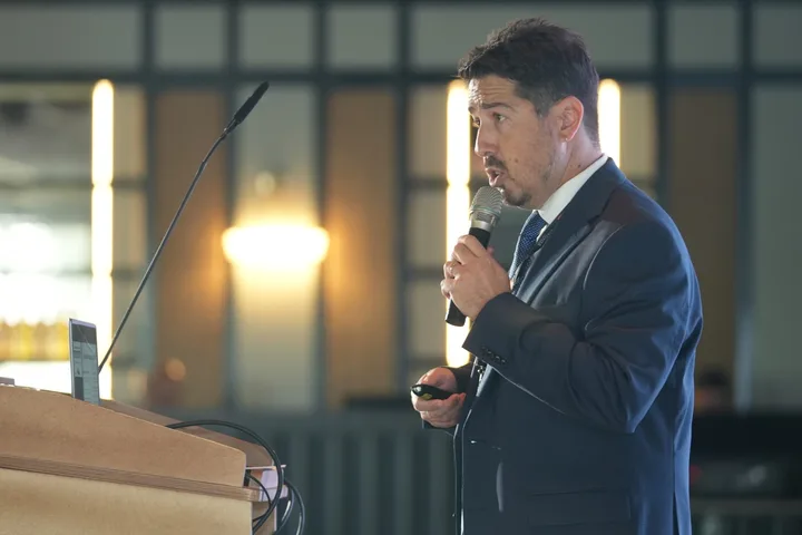 A speaker addressing the conference from the lectern